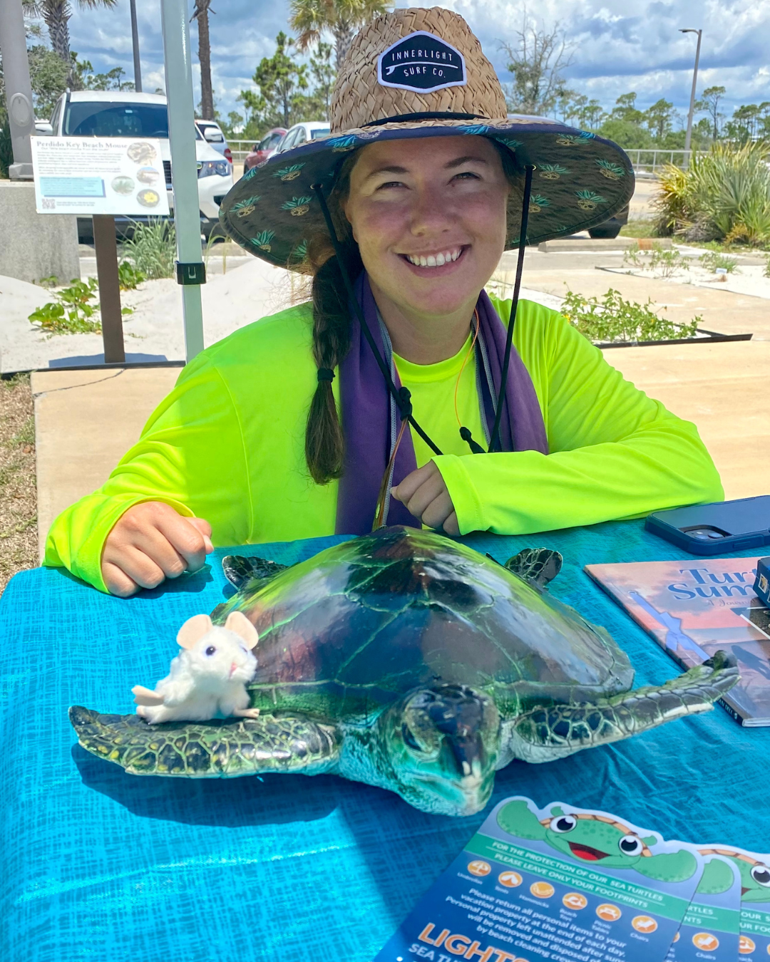 Samantha Bolduc poses behind a sea turtle 
